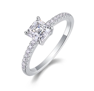 Macro shot of silver ring with square moissanite centerpiece and small side stones