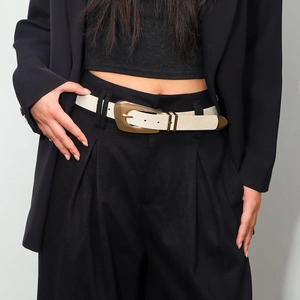 Women's cream braided waist belt with gold irregular metal buckle on black dress