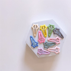 Macro shot of ten colorful star-shaped hair clips in pastel macaron resin colors