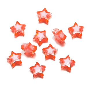 Macro detail of red and white dual-tone acrylic star beads for DIY jewelry making