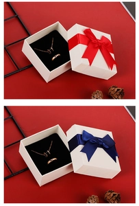 Detail of square jewelry gift boxes with silk bow ribbons and velvet inserts for sets