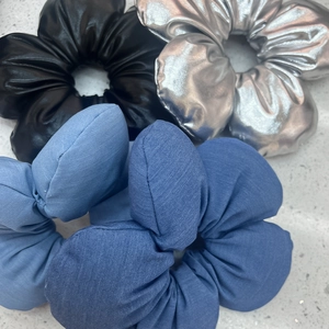 Floral scrunchies set in faux leather and fabric textures in black, silver, and blue colors