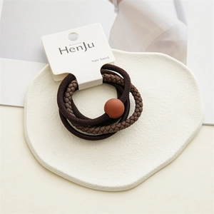 Detail of a 4-piece minimalist brown hair tie set with matte bead and woven texture