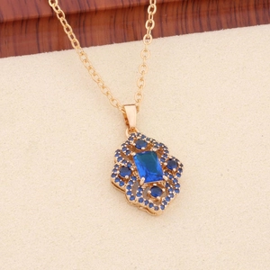 Detailed view of luxury gold necklace with blue rectangle zircon and intricate filigree