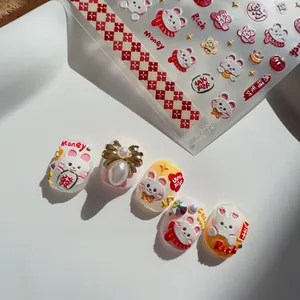 Detail of 3D embossed rabbit nail art stickers with red patterns and pearl bow accents