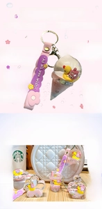 Detail of cartoon character liquid quicksand keychain with pink silicone strap and glitter