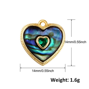 Macro shot showing dimensions of heart-shaped abalone shell pendant with green gemstone