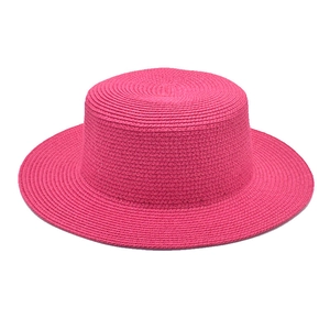 Detail of flat top straw boater hat showing fine pink weave texture and wide brim