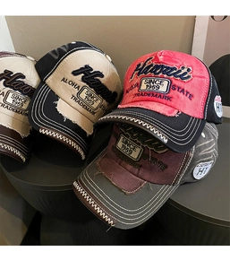 Detailed view of vintage washed baseball caps with Hawaii 3D embroidery and distressed edges