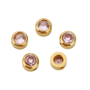 Detailed view of five 6mm gold plated stainless steel beads with pink zircon inlay