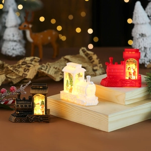 Christmas train candle lantern in bronze, white, and red with warm glowing LED lights