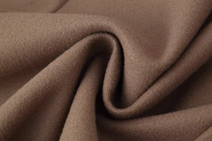 Macro detail of the premium brown wool fabric showing soft texture and high-quality weave