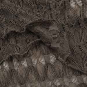 Close-up of deep brown textured knit fabric with geometric diamond mesh patterns