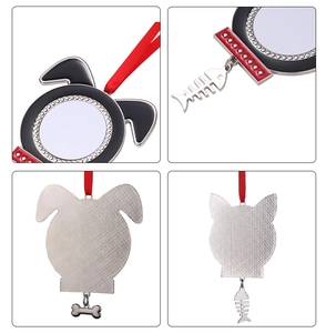 Detail of dog and cat metal pendants with bone and fishbone charms and red ribbons