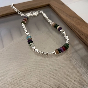 Close-up of heart pearl bracelet with silver crushed beads and colorful gemstones