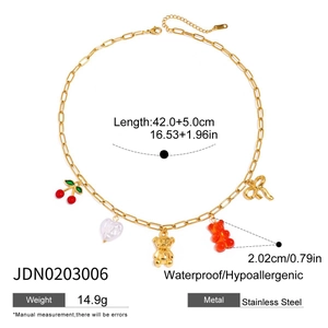 Detailed view of stainless steel charm necklace with gummy bear and cherry pendants