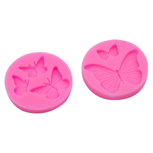 Pink silicone butterfly mold for cake fondant and chocolate decorating on white background