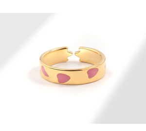Close-up of adjustable 18K gold plated ring featuring pink heart enamel inlay details