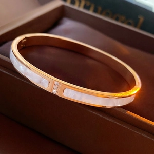 Elegant rose gold titanium steel shell bracelet with triple cubic zirconia stone accents
