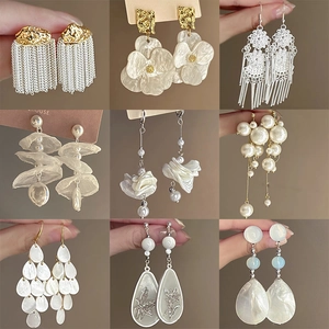 Selection of white flower and pearl earrings in elegant silver needle gold plating finish
