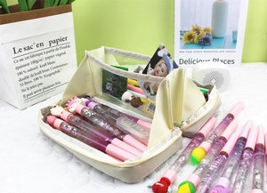 Close-up of large-capacity canvas pencil case with liquid glitter pens and cute 3D charms