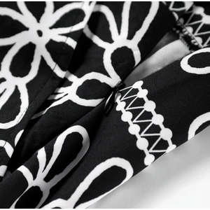 Detailed macro shot of an invisible zipper on black and white floral print fabric
