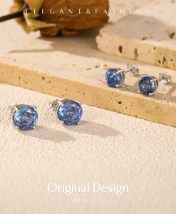 Macro detail of S925 sterling silver stud earrings with royal blue faceted gemstones