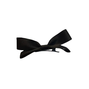Detailed view of back side with metal alligator clip on black satin bow hairpin