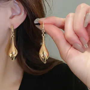 Polished gold liquid teardrop dangle earrings for women with elegant hook design