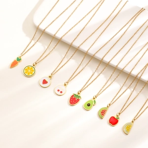Colorful fruit and vegetable enamel pendants on thin gold necklaces displayed on white stairs