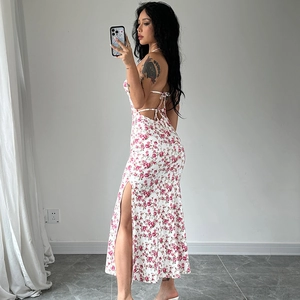 Detail of white floral sundress featuring a side slit and open back design