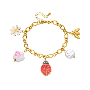 Detailed view of gold stainless steel chain bracelet with bee and daisy charms