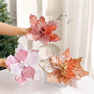 Sparkly glitter Christmas poinsettia flowers in pink and gold for tree decoration