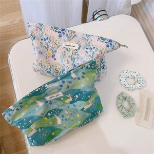 Detail of floral and bunny print cotton makeup bags with a simple wish fabric label