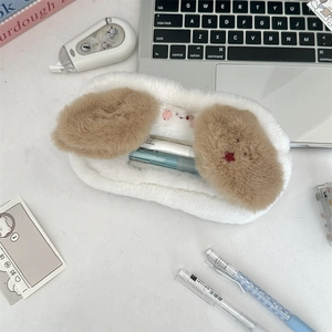 Detailed view of white plush stationery case with fluffy brown ears on a desk