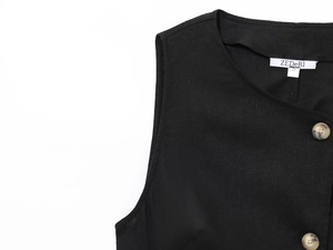 Detailed close-up of black linen blend vest featuring textured fabric and natural buttons