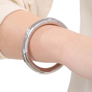 Close-up of polished silver stainless steel bracelet with minimalist geometric facets