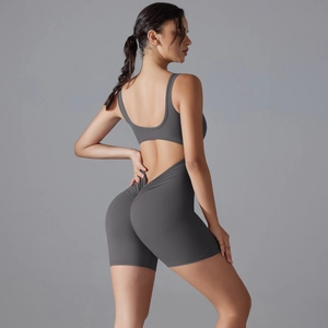 Detail of grey yoga bodysuit featuring back cutout and V-shaped scrunch butt design
