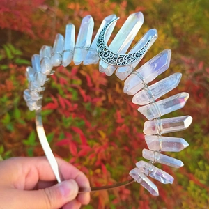 Close-up of handmade iridescent crystal crown with a moon pendant and wire wrapping