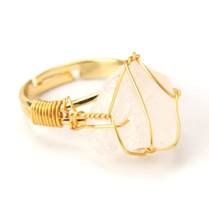 Detail of handmade gold wire wrapped pink natural agate stone on an adjustable ring