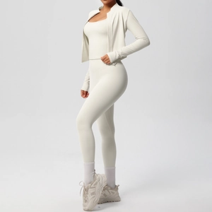 Three-piece beige yoga set featuring cropped jacket, sports bra, and high-waist leggings