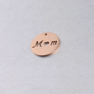 Macro detail of 20mm rose gold round cutout Mom pendant with heart shaped letter O