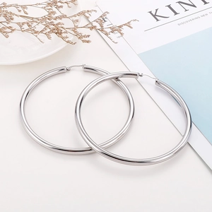 Macro shot of large silver polished hoop earrings with a secure clasp closure