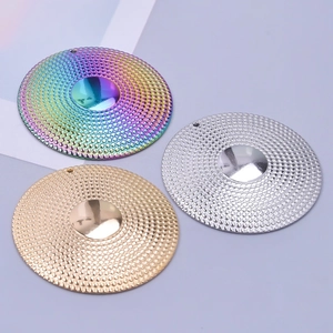 Detail of round textured stainless steel pendants in rainbow, gold, and silver finishes