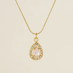 Macro shot of gold water drop necklace with pink pear-cut stone and diamond halo