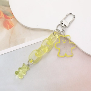 Close-up of dual yellow acrylic bear charms with a chunky chain on a silver keychain