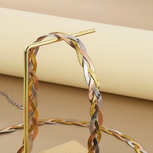 Detailed view of tricolor braided snake chain in gold silver and rose gold finish