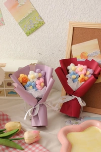 Detail of colorful knitted crochet bouquets with Eternal ribbons and red paper wrap
