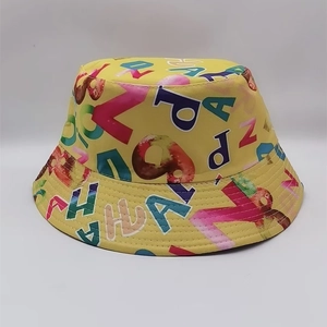 Detail of vibrant yellow bucket hat featuring colorful all-over graphic letter print