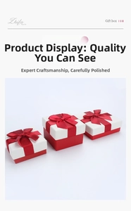 Detailed view of square gift boxes with red silk bows and elegant red and white contrast